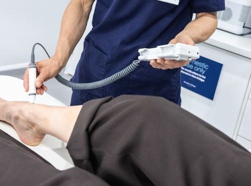 A clinician performing a Doppler assessment at the Gentell Wound Care Clinic, Health Village Esher